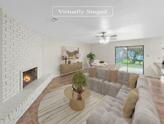 tiled living room featuring ceiling fan, brick wall, and a fireplace