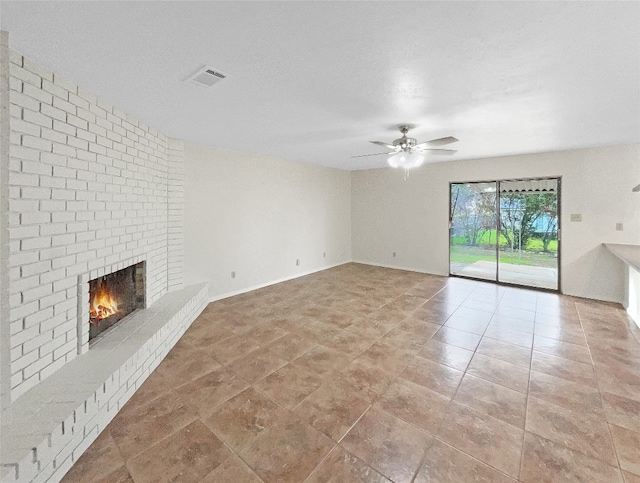 unfurnished living room with ceiling fan, a brick fireplace, and light tile floors