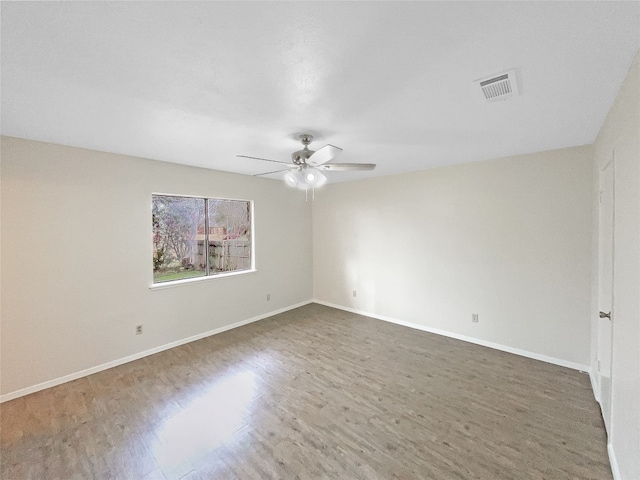 unfurnished room featuring ceiling fan and dark hardwood / wood-style flooring