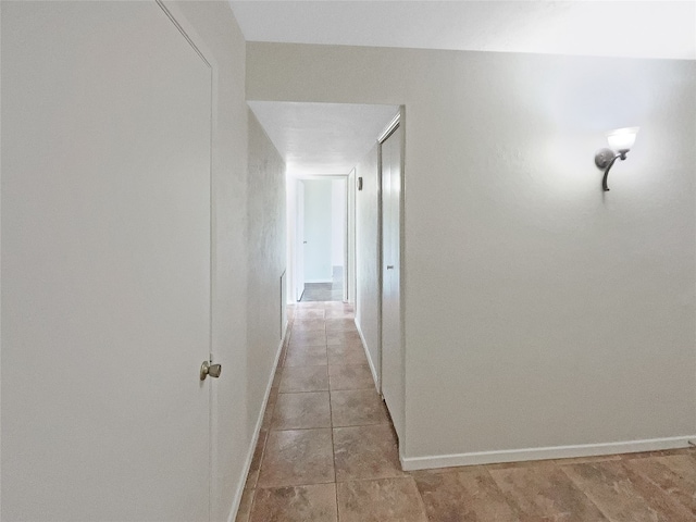 corridor featuring light tile floors