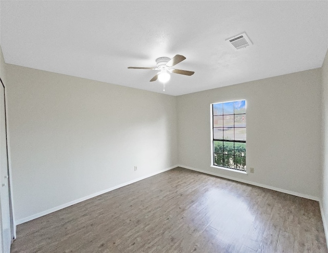 unfurnished room with dark hardwood / wood-style flooring and ceiling fan