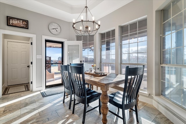 dining area featuring crown molding and an inviting chandelier