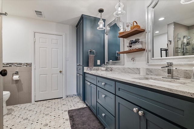 bathroom with vanity, a shower, and toilet