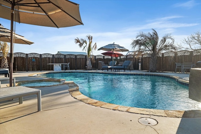 view of pool with a patio and an in ground hot tub