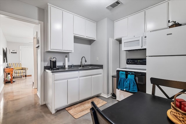 kitchen with white cabinets, sink, and white appliances