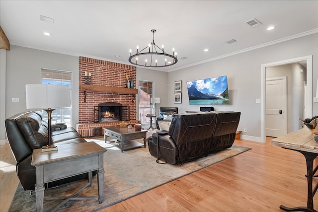 living room featuring light hardwood / wood-style floors, a wealth of natural light, and a brick fireplace