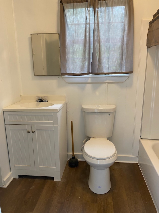 full bathroom with hardwood / wood-style floors, vanity, toilet, and bathing tub / shower combination