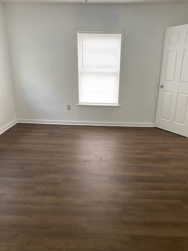 spare room with dark hardwood / wood-style floors