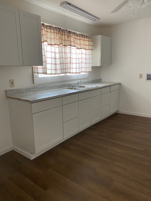 kitchen with white cabinets, sink, dark hardwood / wood-style floors, and ceiling fan