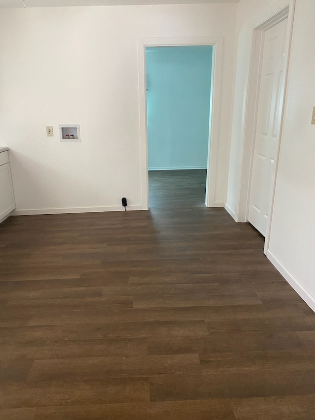 interior space with dark hardwood / wood-style floors and hookup for a washing machine