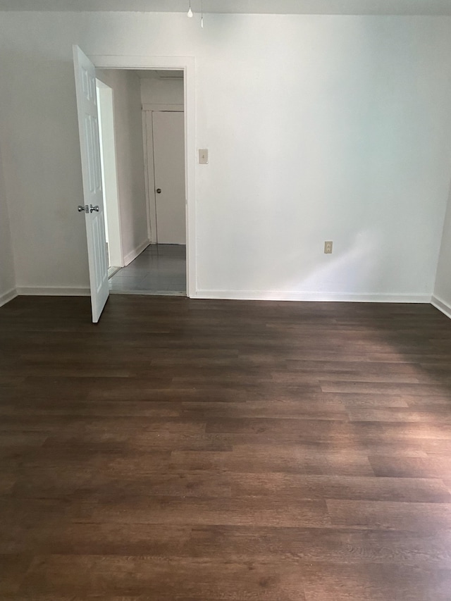 empty room with dark hardwood / wood-style floors