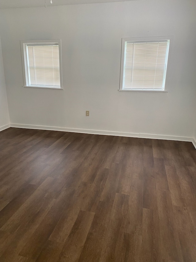 unfurnished room with dark hardwood / wood-style floors