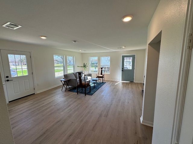 living room featuring light hardwood / wood-style floors and a wealth of natural light