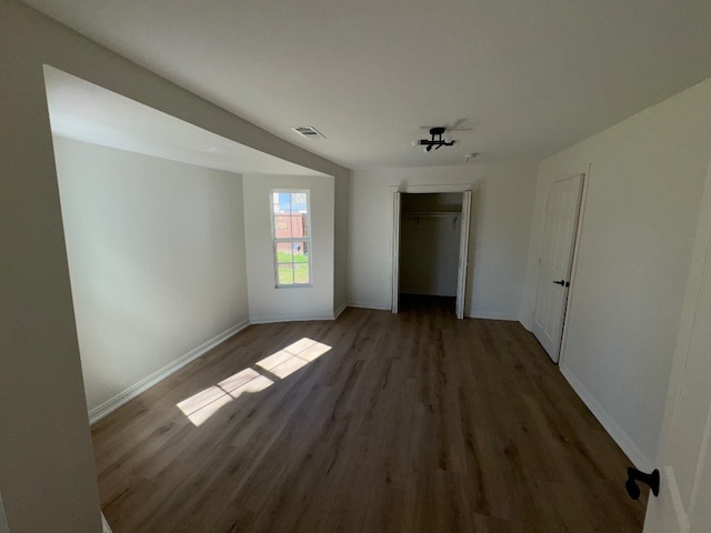 empty room with dark hardwood / wood-style floors