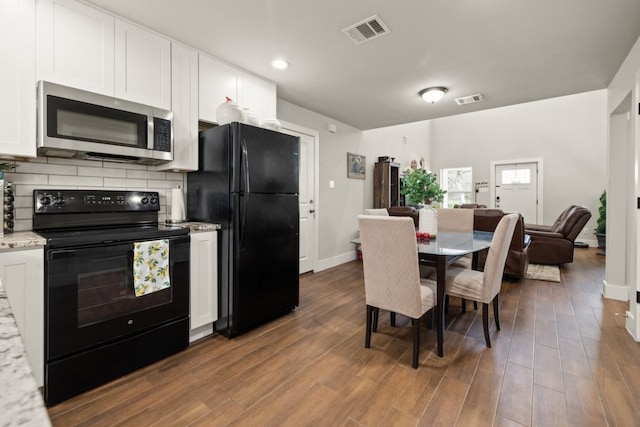 kitchen featuring white cabinetry, dark hardwood / wood-style floors, and black appliances