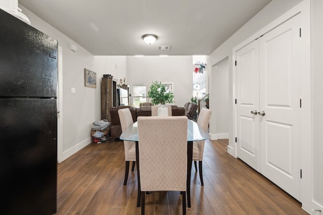 dining space featuring dark hardwood / wood-style floors