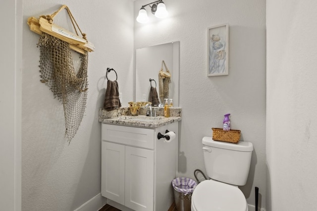 bathroom featuring oversized vanity and toilet