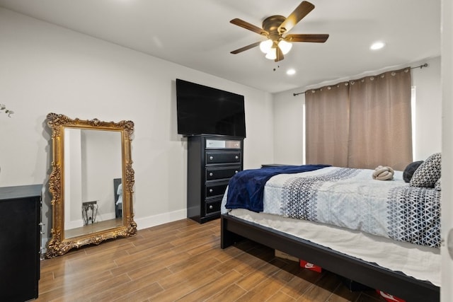 bedroom with light hardwood / wood-style floors and ceiling fan