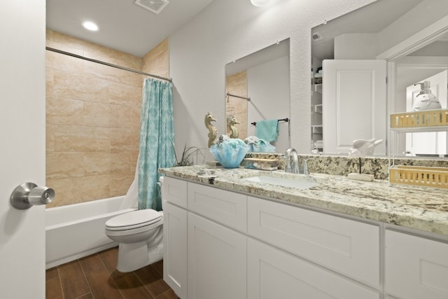 full bathroom featuring vanity, shower / bath combo, hardwood / wood-style floors, and toilet