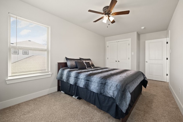 carpeted bedroom featuring a closet and ceiling fan