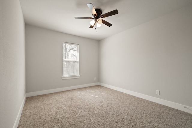 empty room with light colored carpet and ceiling fan