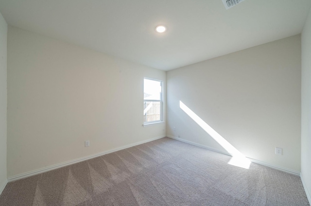 empty room featuring light carpet