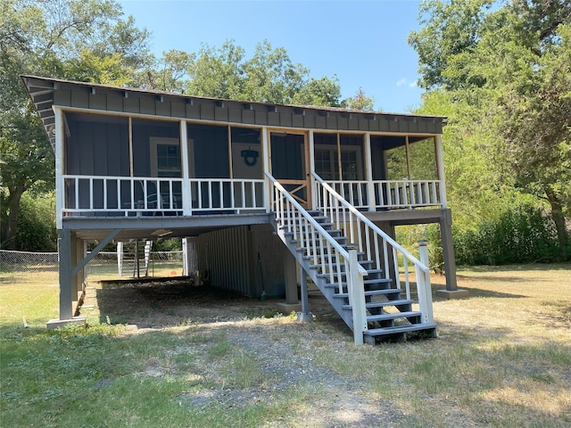 view of front of house with stairs, driveway, and board and batten siding