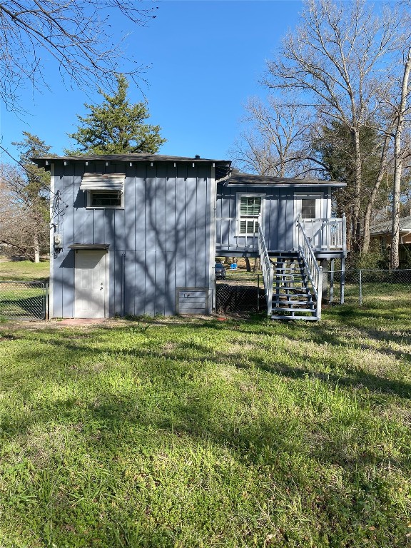 view of outdoor structure with stairway and fence