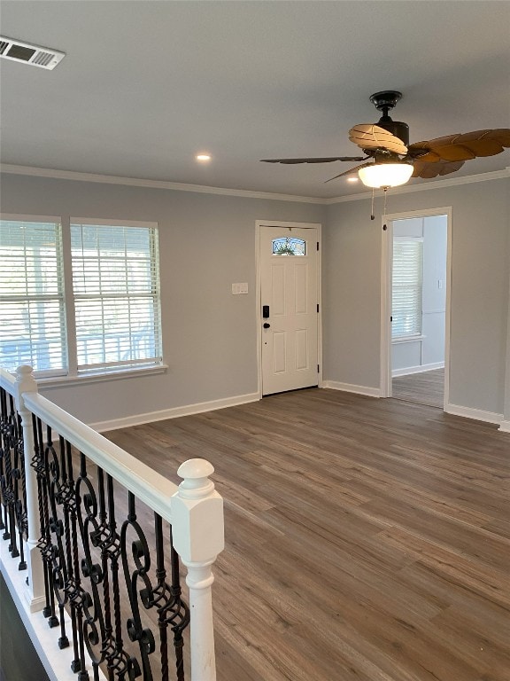 foyer entrance with hardwood / wood-style flooring, crown molding, and ceiling fan