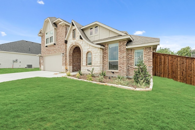 view of front of house featuring a front yard, central AC, and a garage