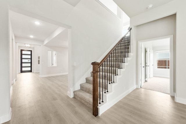 stairs with hardwood / wood-style floors