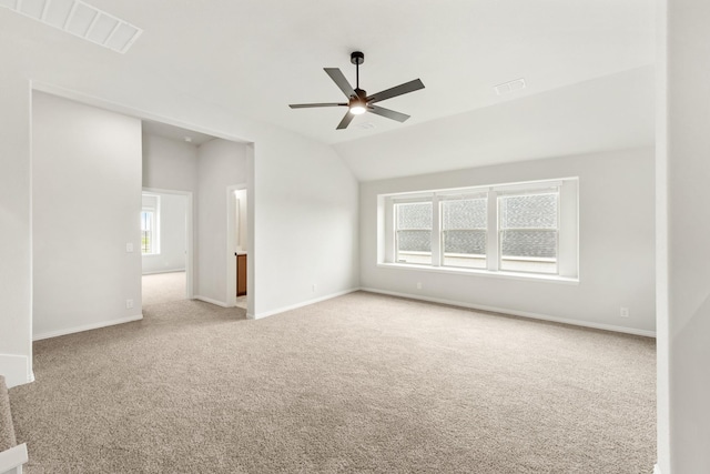 carpeted empty room featuring ceiling fan and vaulted ceiling