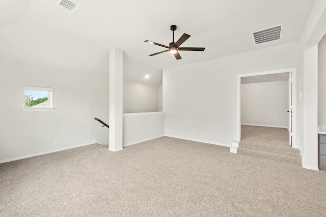 carpeted empty room with ceiling fan and vaulted ceiling