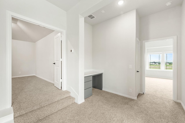 hallway with light colored carpet