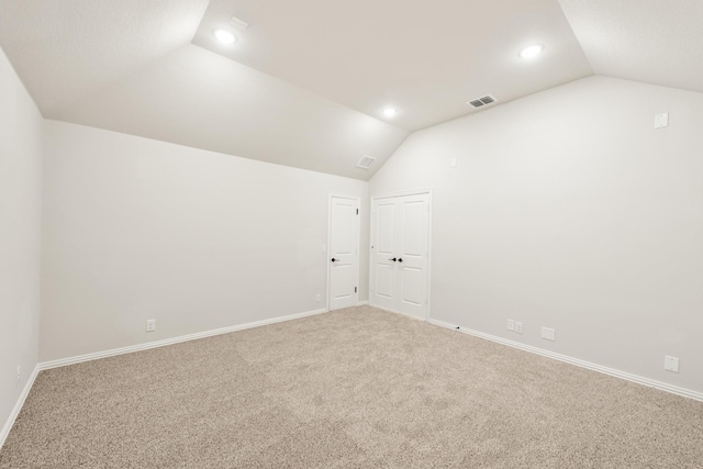 interior space featuring carpet floors and vaulted ceiling