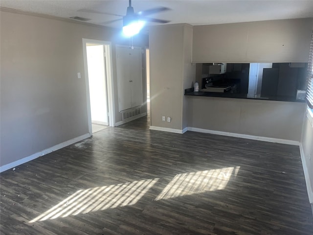 unfurnished living room featuring ceiling fan and dark hardwood / wood-style flooring