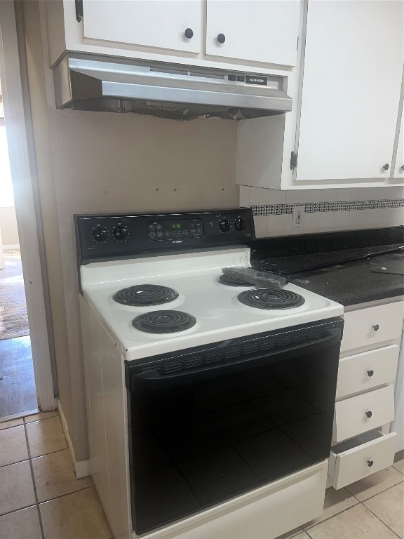 interior space featuring tasteful backsplash, wall chimney range hood, white electric range oven, and light tile floors