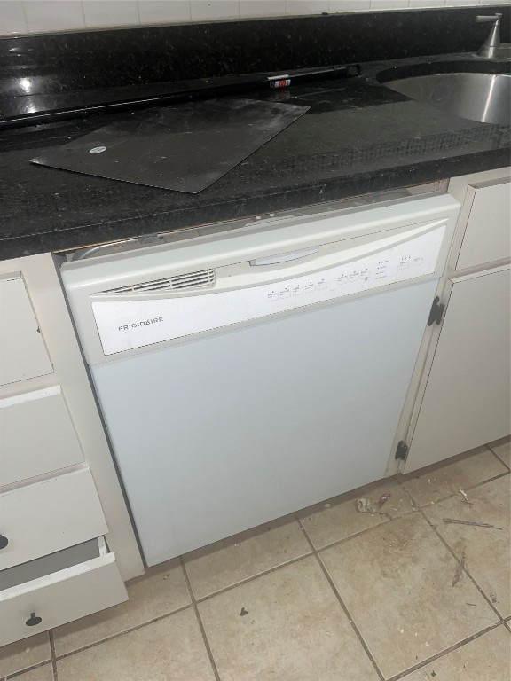 details featuring light tile flooring and dishwasher