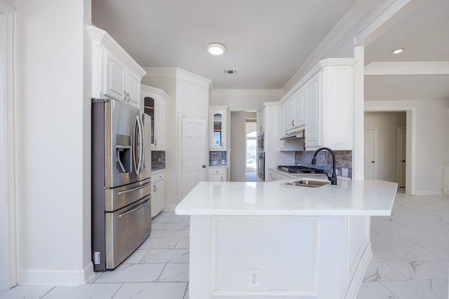 kitchen with light tile floors, white cabinetry, backsplash, and stainless steel fridge