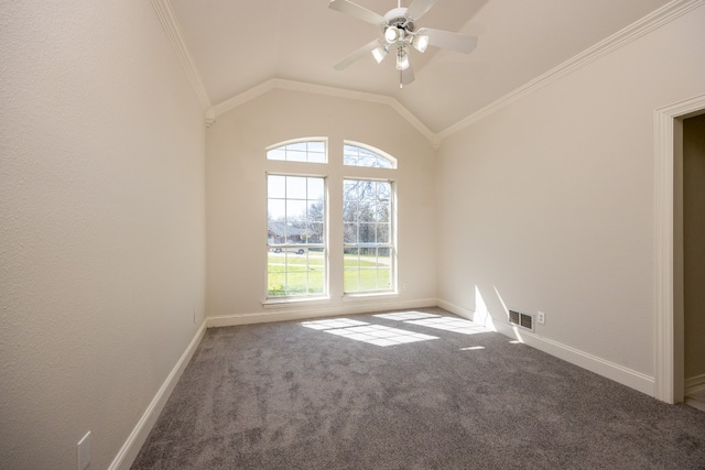 carpeted empty room featuring ceiling fan, crown molding, and vaulted ceiling