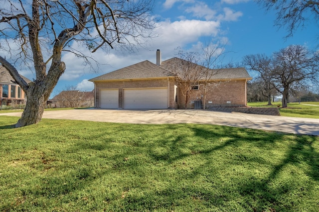 view of front of property with a front lawn, central AC, and a garage