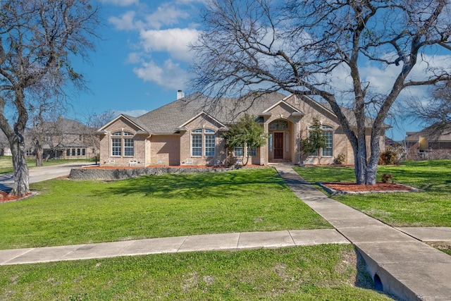 ranch-style home featuring a front lawn