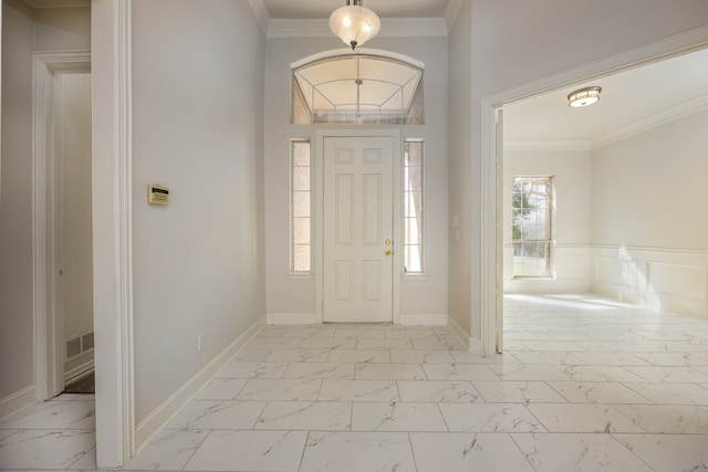 entryway featuring ornamental molding and light tile floors