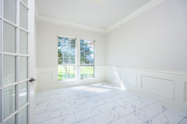 tiled empty room featuring crown molding, plenty of natural light, and french doors