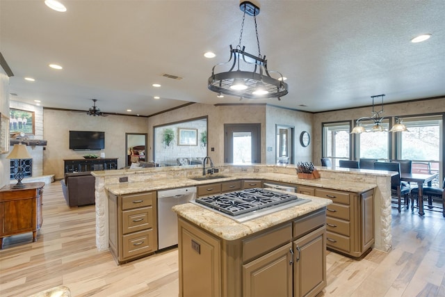 kitchen with a kitchen island, stainless steel appliances, decorative light fixtures, and light hardwood / wood-style floors