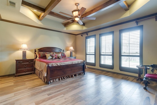 bedroom with light wood-type flooring, ceiling fan, coffered ceiling, and beam ceiling