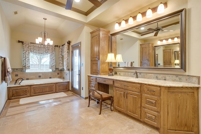 bathroom featuring tile patterned flooring, a washtub, ceiling fan with notable chandelier, vanity, and a raised ceiling