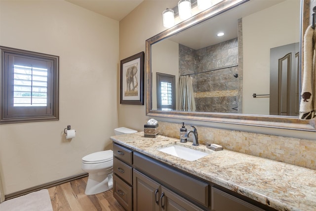 bathroom with vanity, toilet, and hardwood / wood-style floors