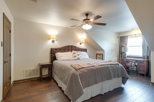 bedroom with dark hardwood / wood-style floors, a textured ceiling, and ceiling fan