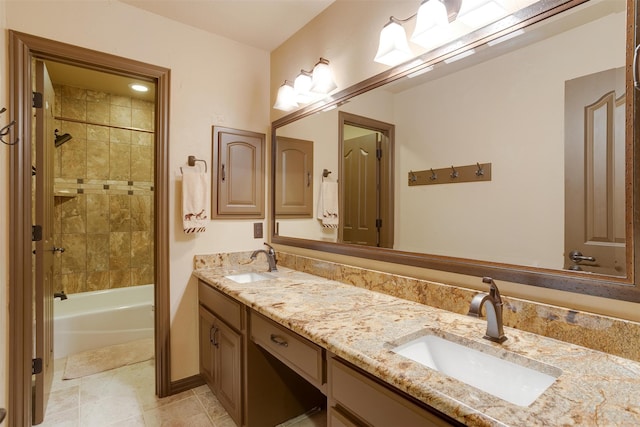 bathroom with tiled shower / bath, tile patterned flooring, and dual bowl vanity